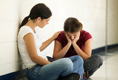 Girl comforting a friend